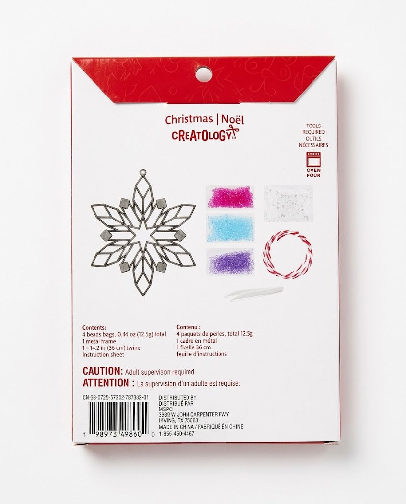 Back of Creatology Christmas snowflake suncatcher box showing DIY components: metal frame, 4 colored melting bead packs, tweezers, and twine; holiday craft kits in Lebanon.
