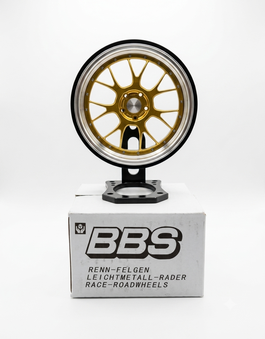 Gold miniature 10cm car rim mounted on desktop stand displayed above white collector box