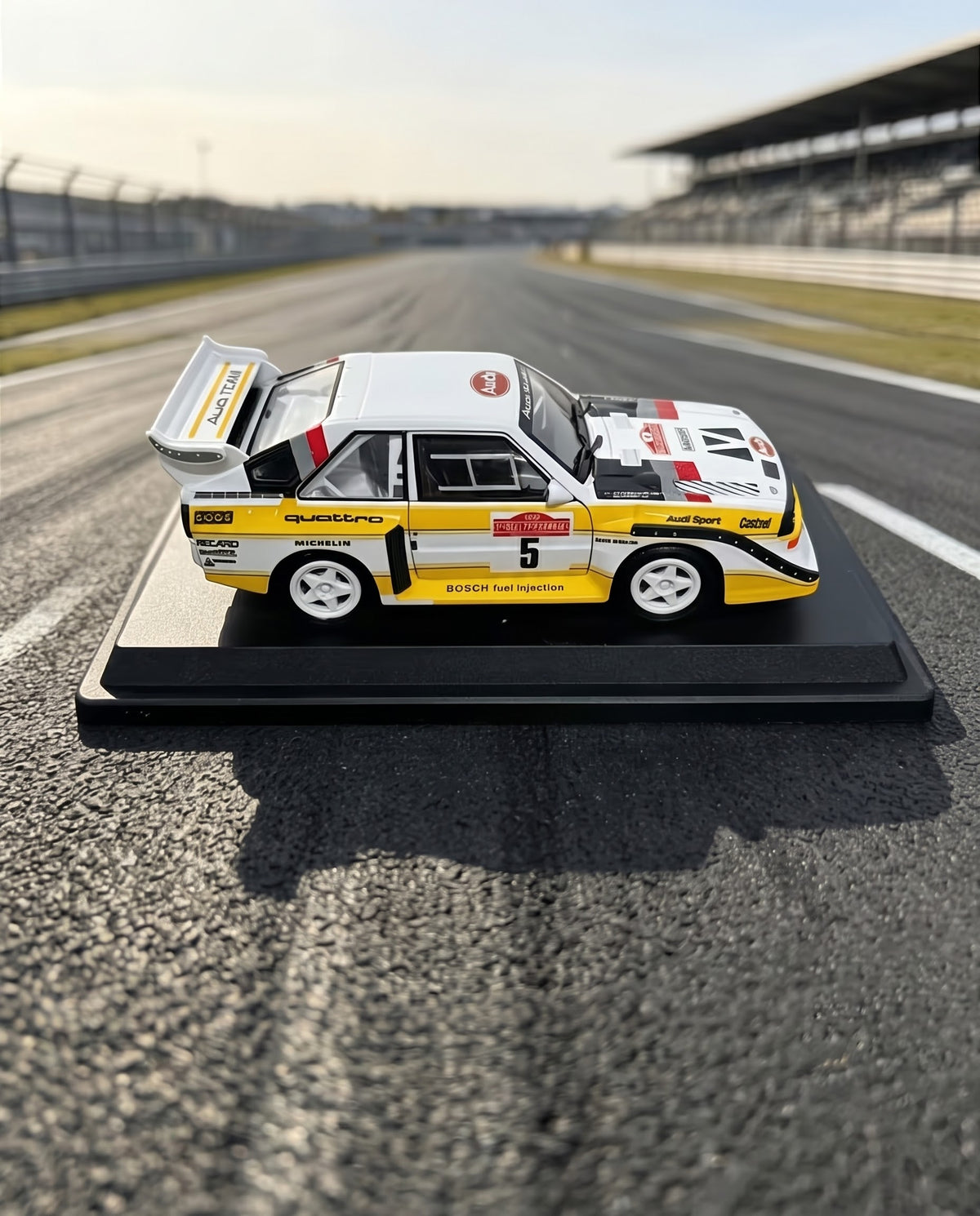 Side profile and Michelin white wheels on the 1:24 Bburago 1985 Audi Sport quattro S1 E2 Sanremo livery rally model car