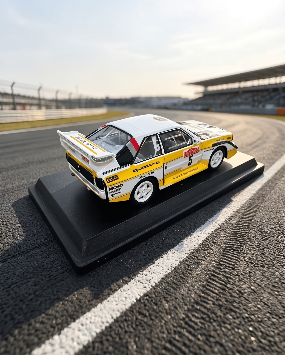Rear three-quarter perspective of the 1985 Audi Sport quattro S1 E2 diecast car highlighting the iconic Group B rear wing and quattro diffuser.
