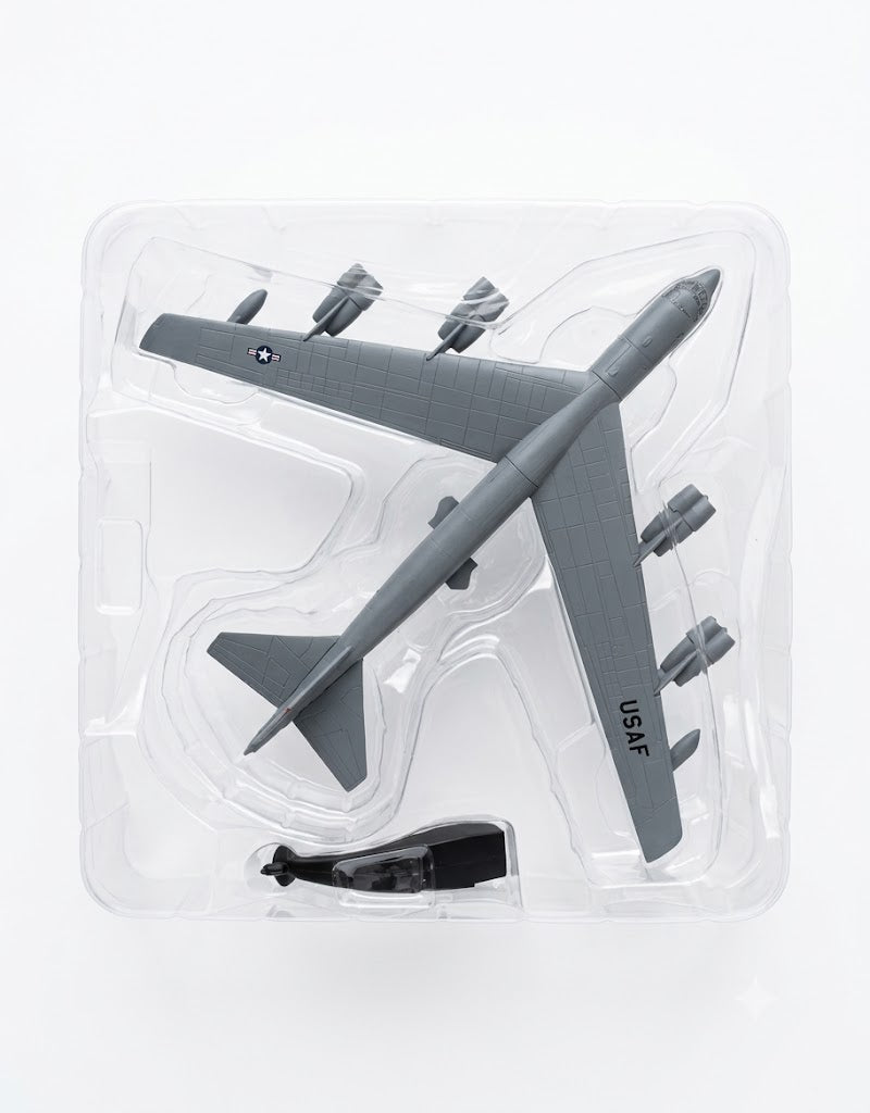 Top-down view of 1:200 scale B-52 bomber diecast model securely packed in clear protective blister tray with stand.