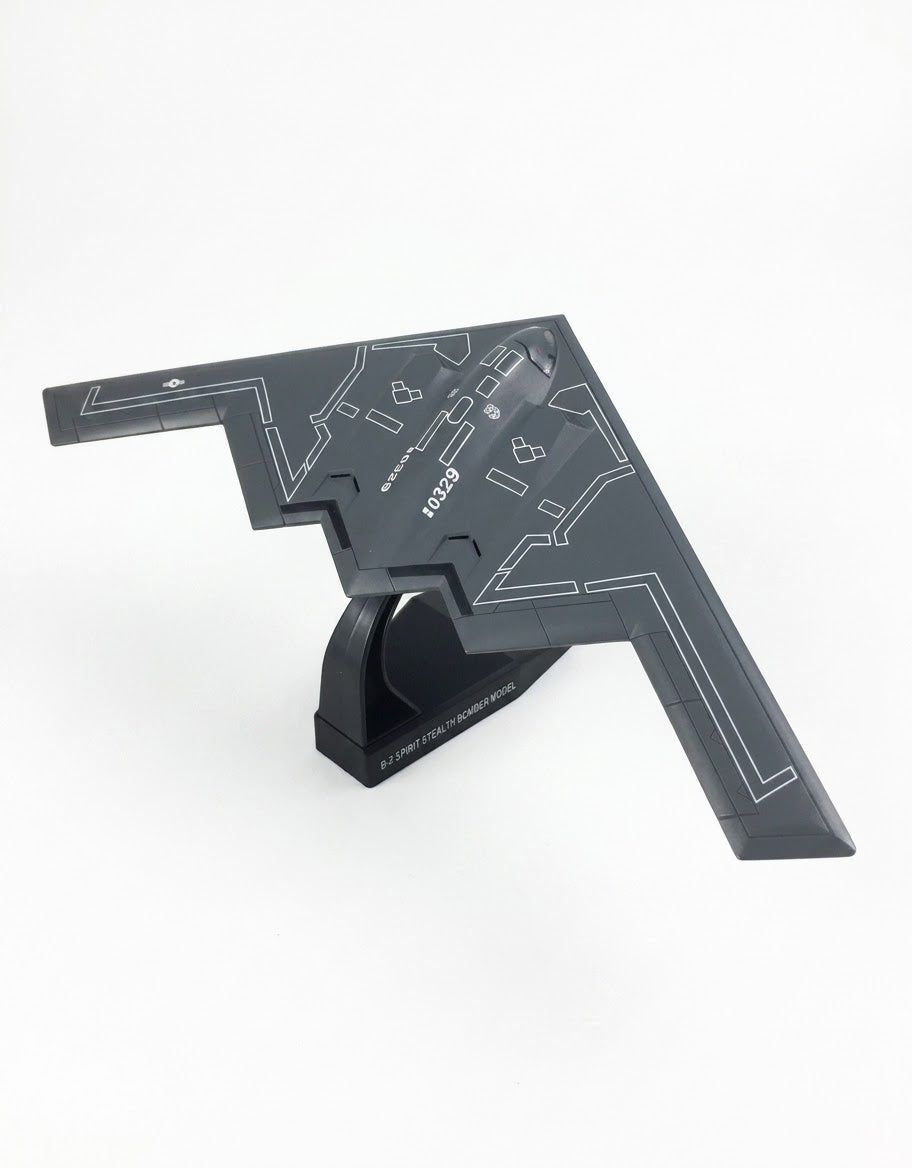 Rear angle view of 1:200 B-2 Spirit stealth bomber diecast model mounted on labeled black display stand base