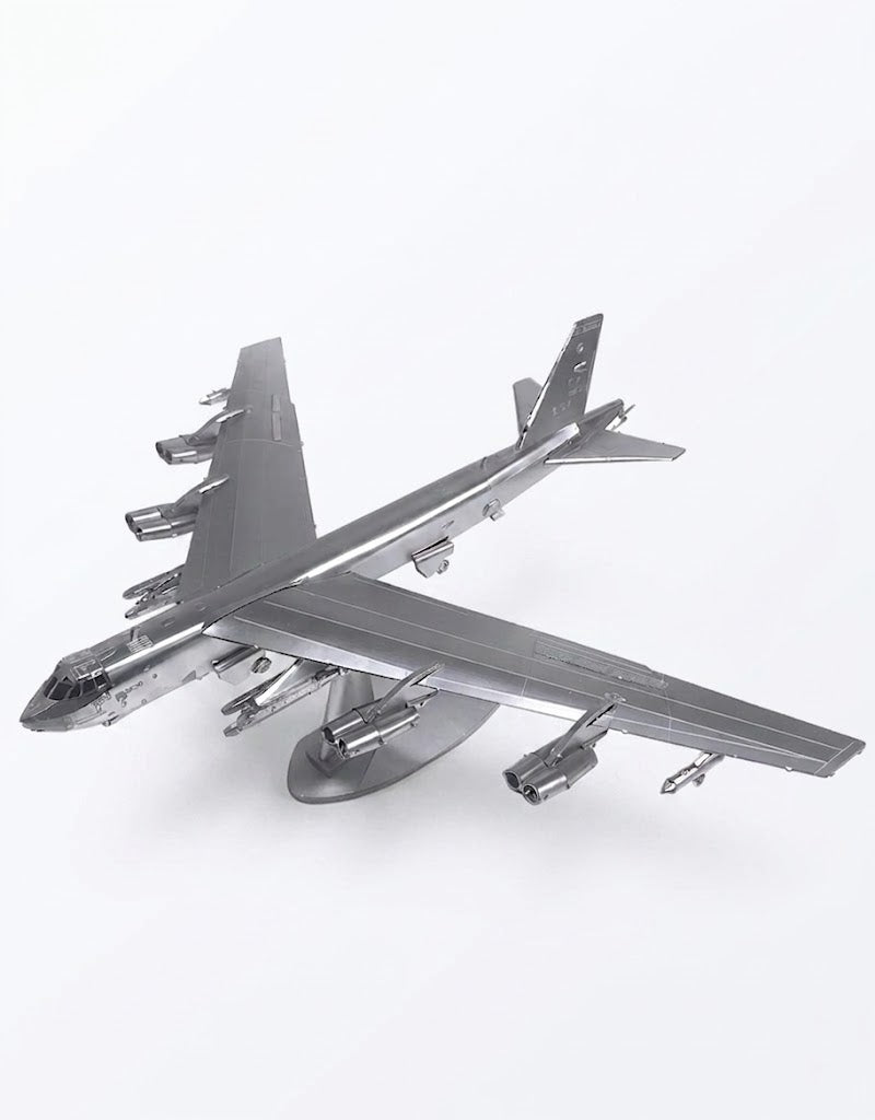Fully assembled B-52 Stratofortress 3D metal puzzle model airplane mounted on a silver display stand.