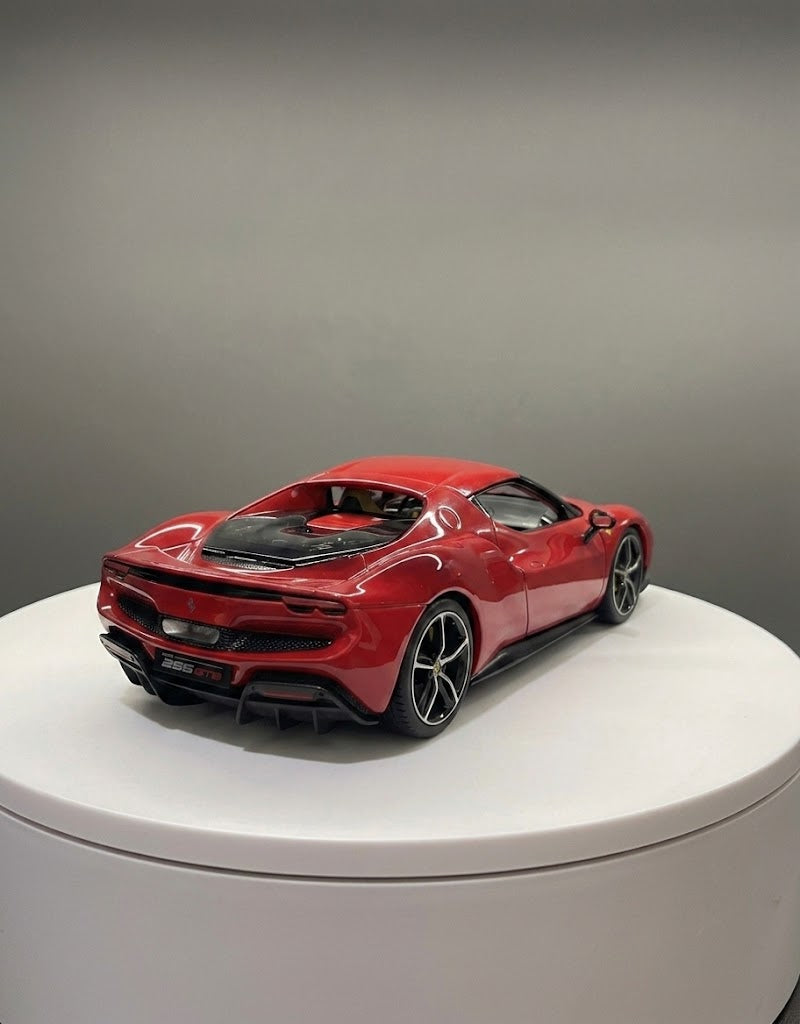 Rear three-quarter studio view of 1:18 scale Bburago Ferrari 296 GTB diecast model showing aerodynamic diffuser and taillights