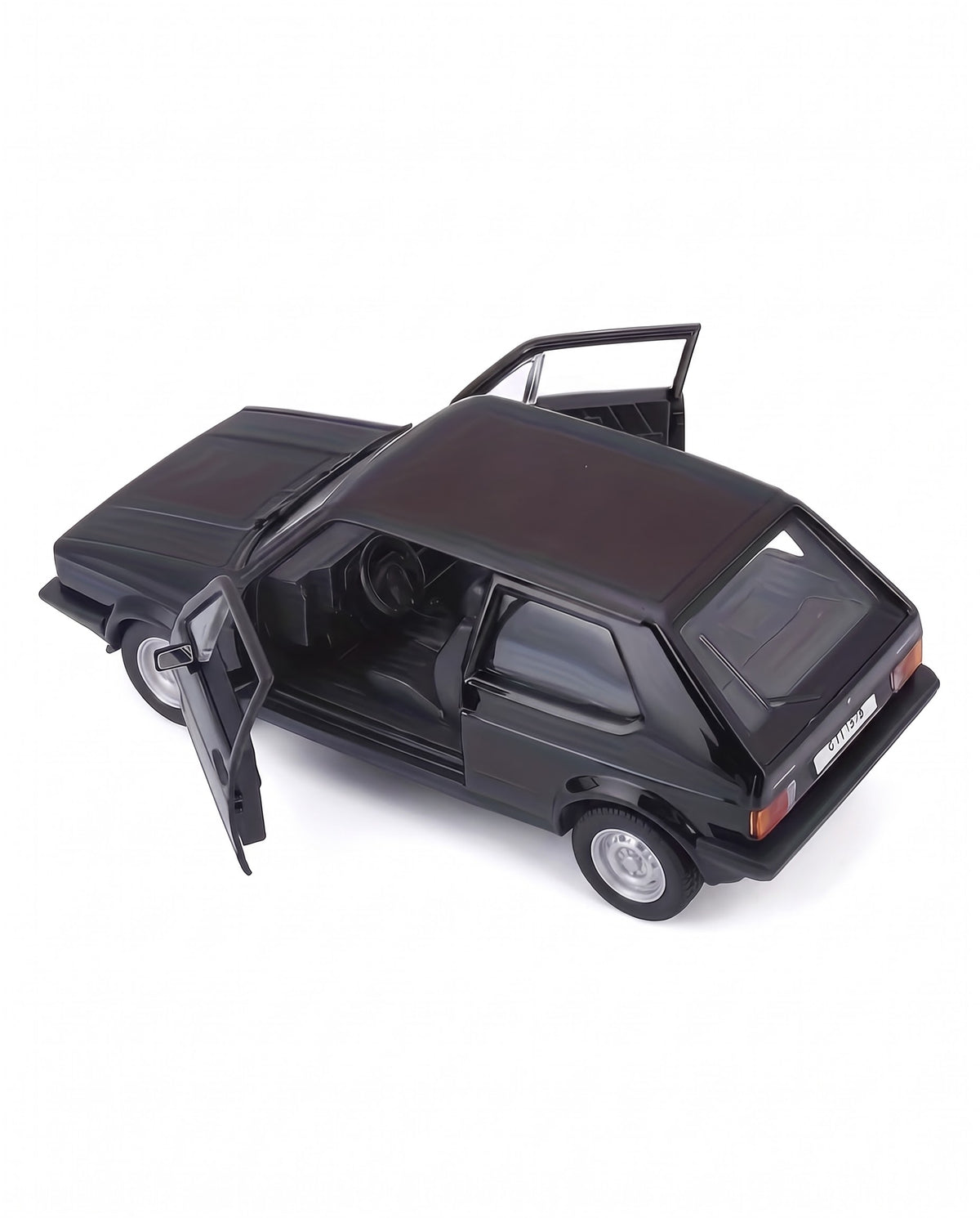 Overhead view of 1:24 1979 VW Golf GTI Mk1 diecast car in gloss black with open front doors showing steering wheel and dashboard interior details.