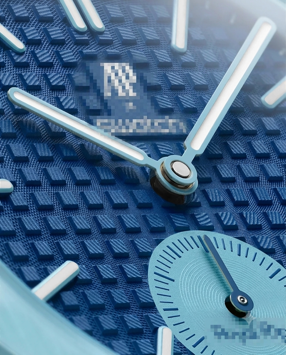 Close-up detail of textured blue waffle pattern dial, subdial, and luminous hands.