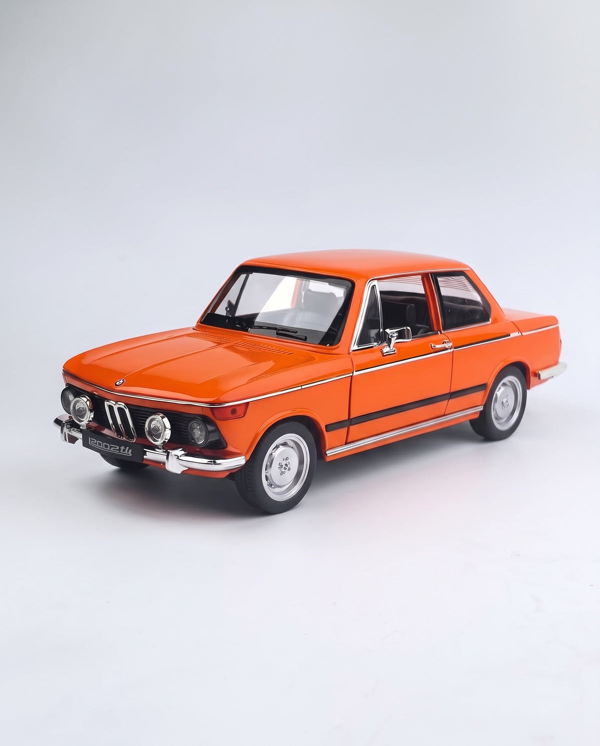 Orange 1:18 scale BMW 2002 tii vintage classic diecast alloy collector car studio hero shot on a seamless white background, ideal gift for car enthusiasts in Lebanon.