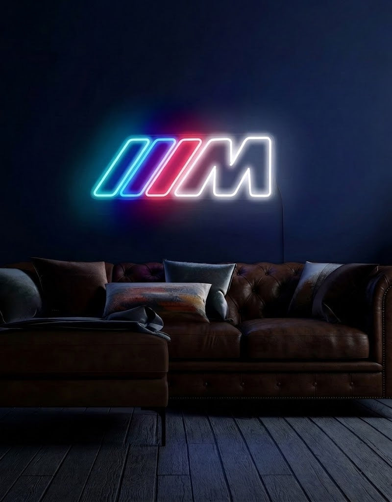 Illuminated BMW M Power LED neon sign glowing on a dark wall above a leather sofa.