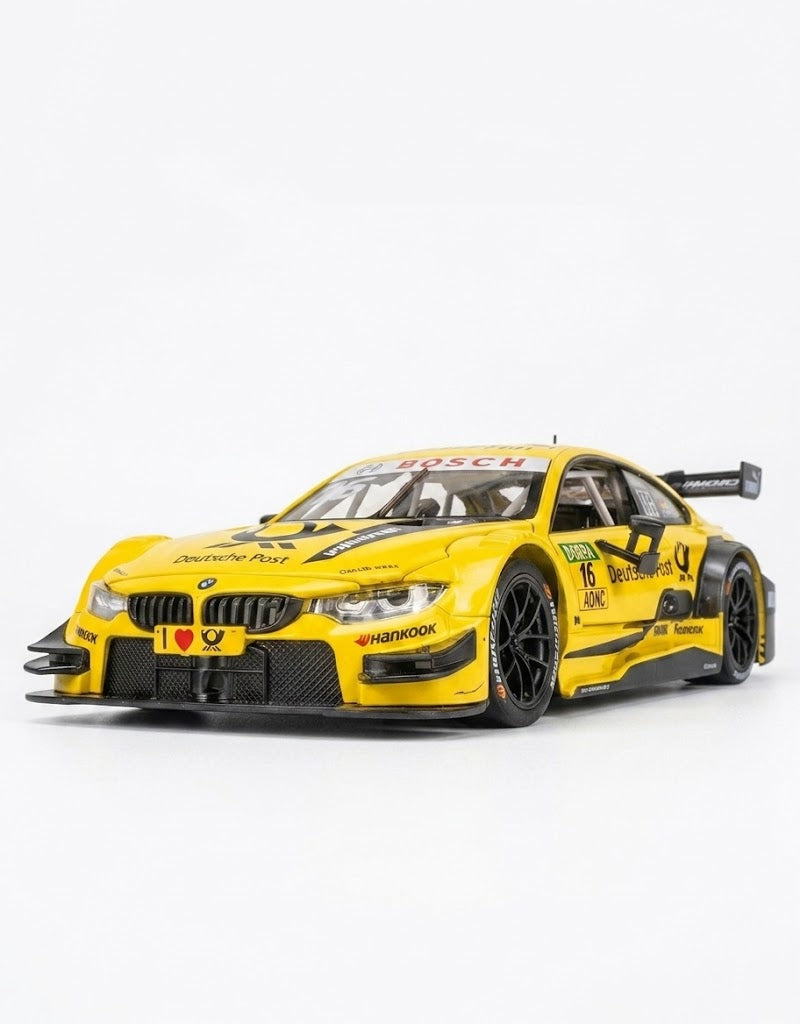Studio shot of 1:24 yellow BMW M4 DTM Deutsche Post livery diecast metal model on a white background.