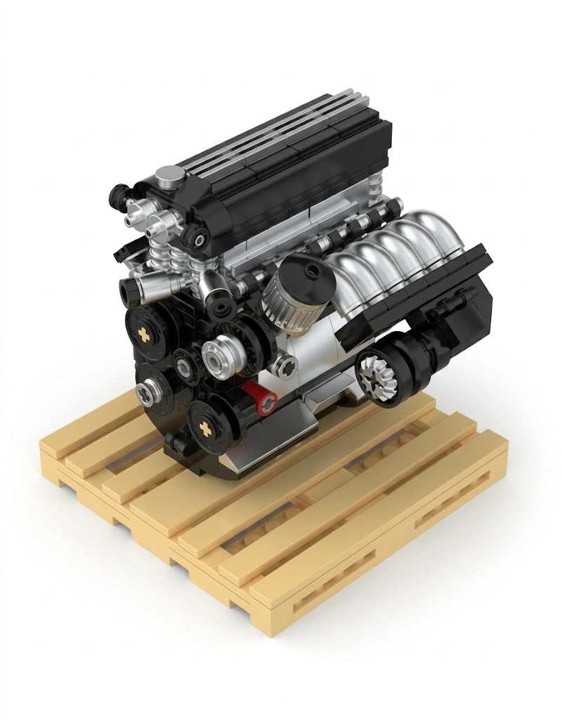 Assembled S50 M3 inline six engine building kit displayed on miniature wooden shipping pallet.