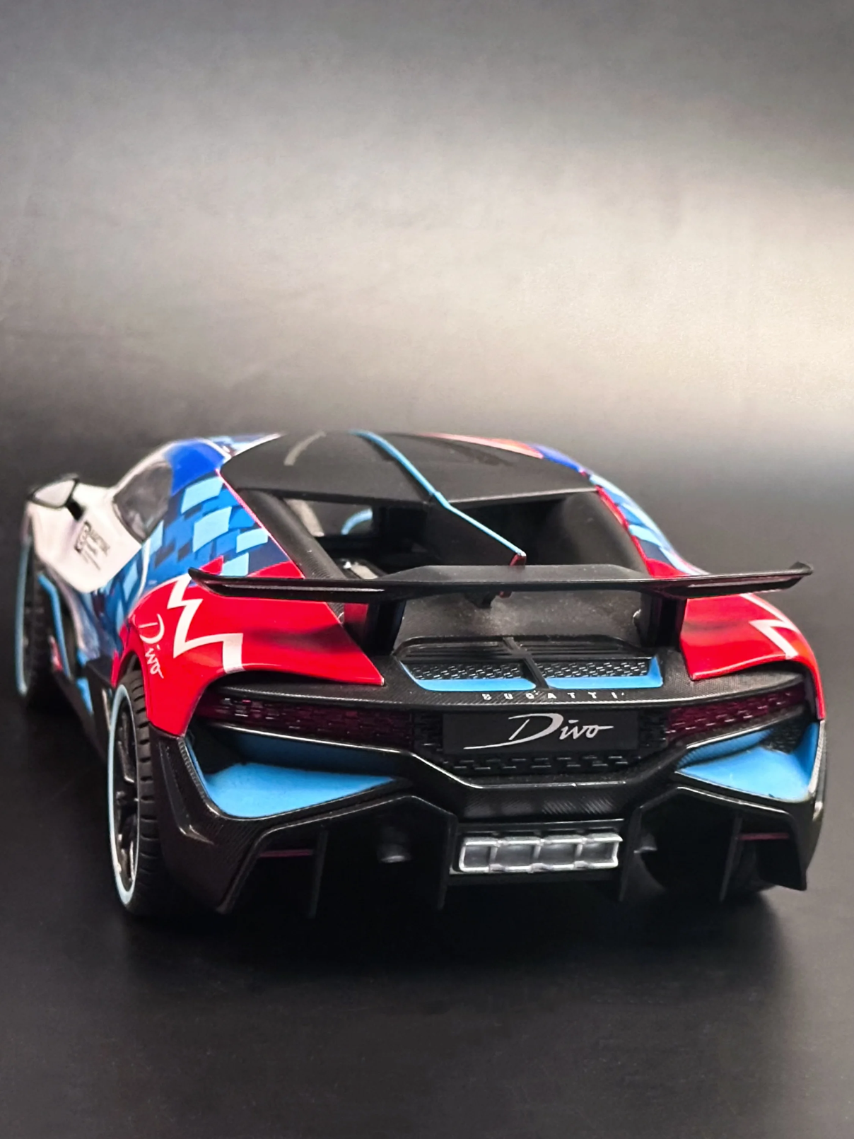 Rear view of 1:18 scale Bugatti Divo diecast model showcasing the aerodynamic wing, quad exhaust tips, and rear diffuser.
