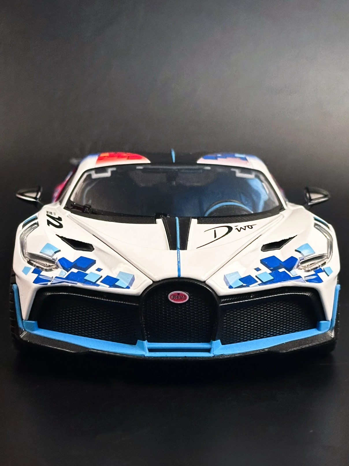 Front view of 1:18 scale Bugatti Divo diecast metal car featuring signature horseshoe grille and geometric racing decals.