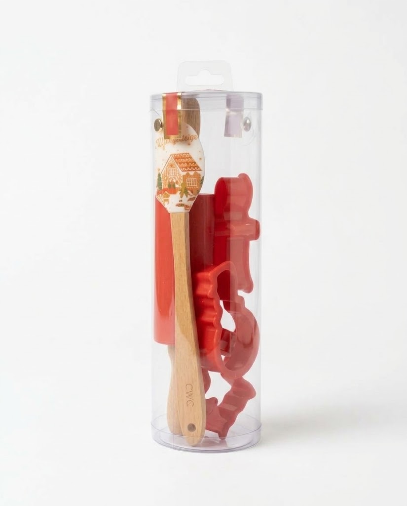 Classic red Christmas mini baking kit inside clear tube with gingerbread house silicone spatula, wooden rolling pin, and gingerbread man cutters.