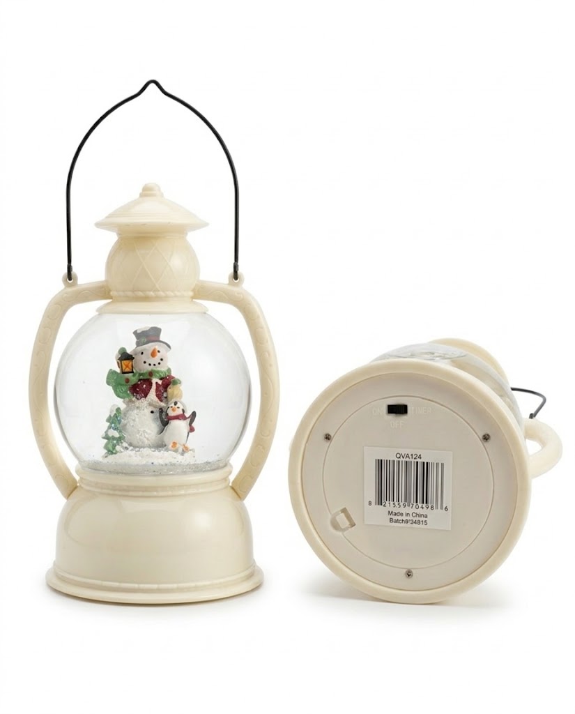 Under-base view of ivory Christmas snow globe lantern showing the battery compartment and 3-way ON, OFF, and TIMER switch.