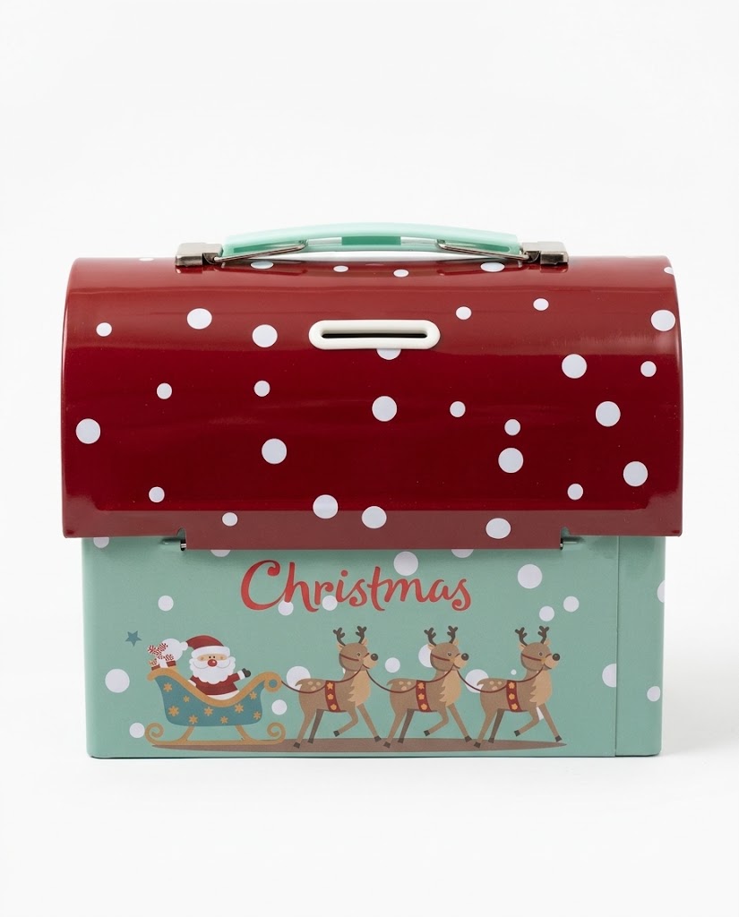 Front view of retro Christmas metal tin savings box showing coin slot, polka-dot red lid, and Santa in a reindeer sleigh on a white background.
