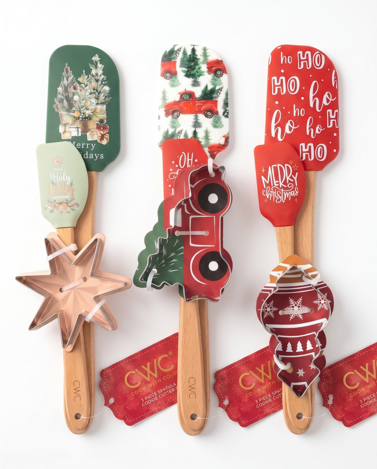 Complete collection of Cook With Color 3-piece holiday baking sets including star tree, vintage red truck, and red ornament spatulas with cookie cutters, online at Gadgets Lebanon.