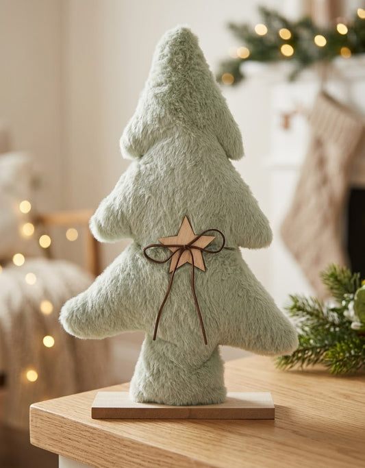 Mint sage green fluffy fabric Christmas tree decoration with rustic wooden star and ribbon on a natural wood stand.