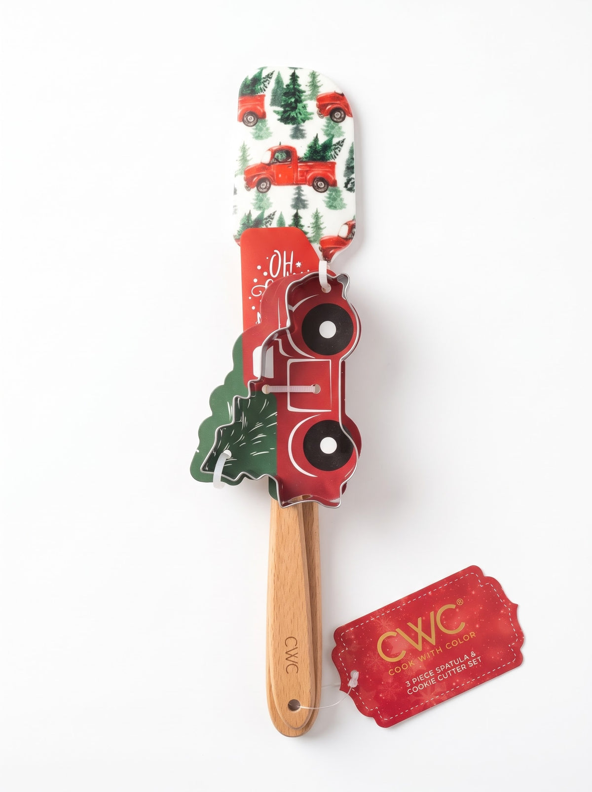 Cook With Color 3-piece holiday baking set with vintage red farm truck and pine tree patterned silicone spatula, mini spatula, and red truck cookie cutter, sold in Lebanon.