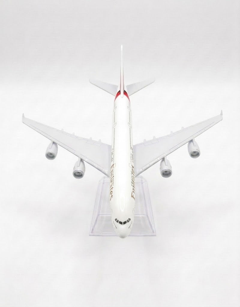 Top-down aerial perspective of Emirates Airlines Airbus A380 diecast collector airplane showing wing details and livery.