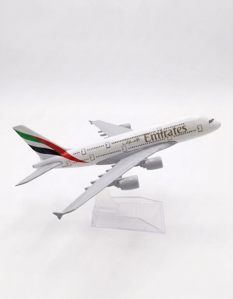 Side profile view of 15cm Emirates Airlines metal diecast model aircraft displayed in flight position on clear base.