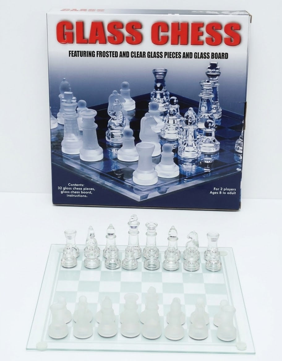 Glass chess set box packaging with 32 frosted and clear glass pieces set up on a glass board