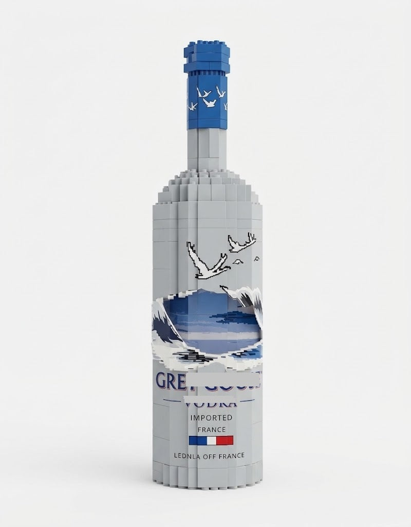 Tall frosted grey collector bottle building block model kit featuring a blue cap with geese motifs and scenic mountain artwork on a white background.