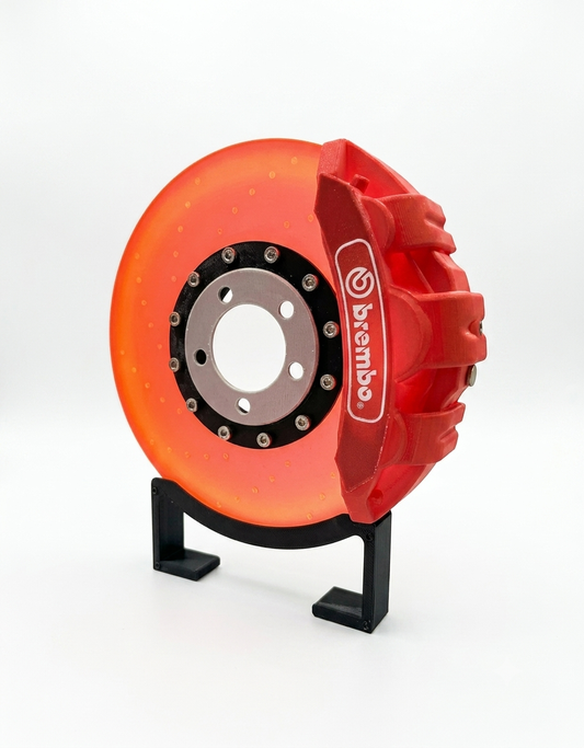 Automotive LED glowing brake disc rotor desk lamp with red brake caliper and display stand.