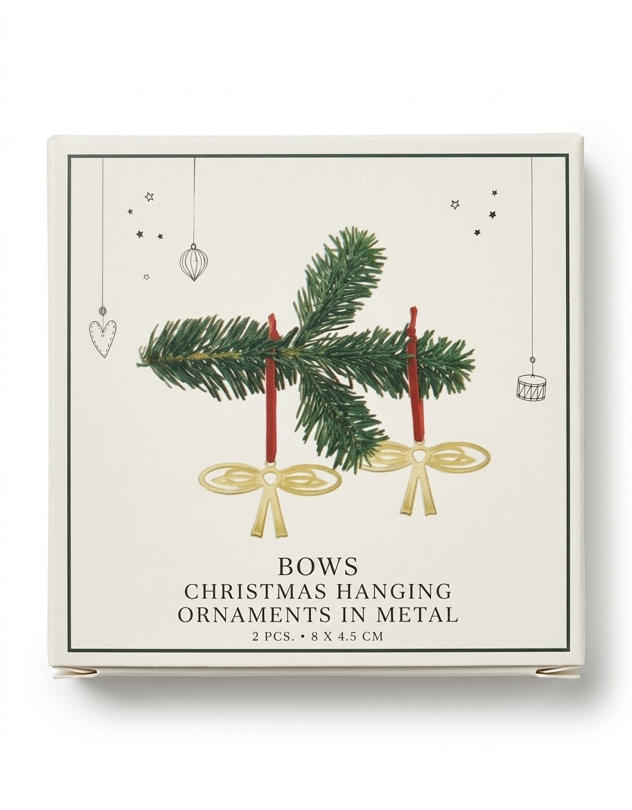Set of two gold metal bow Christmas tree hanging ornaments with red ribbon ties in Nordic gift box packaging.