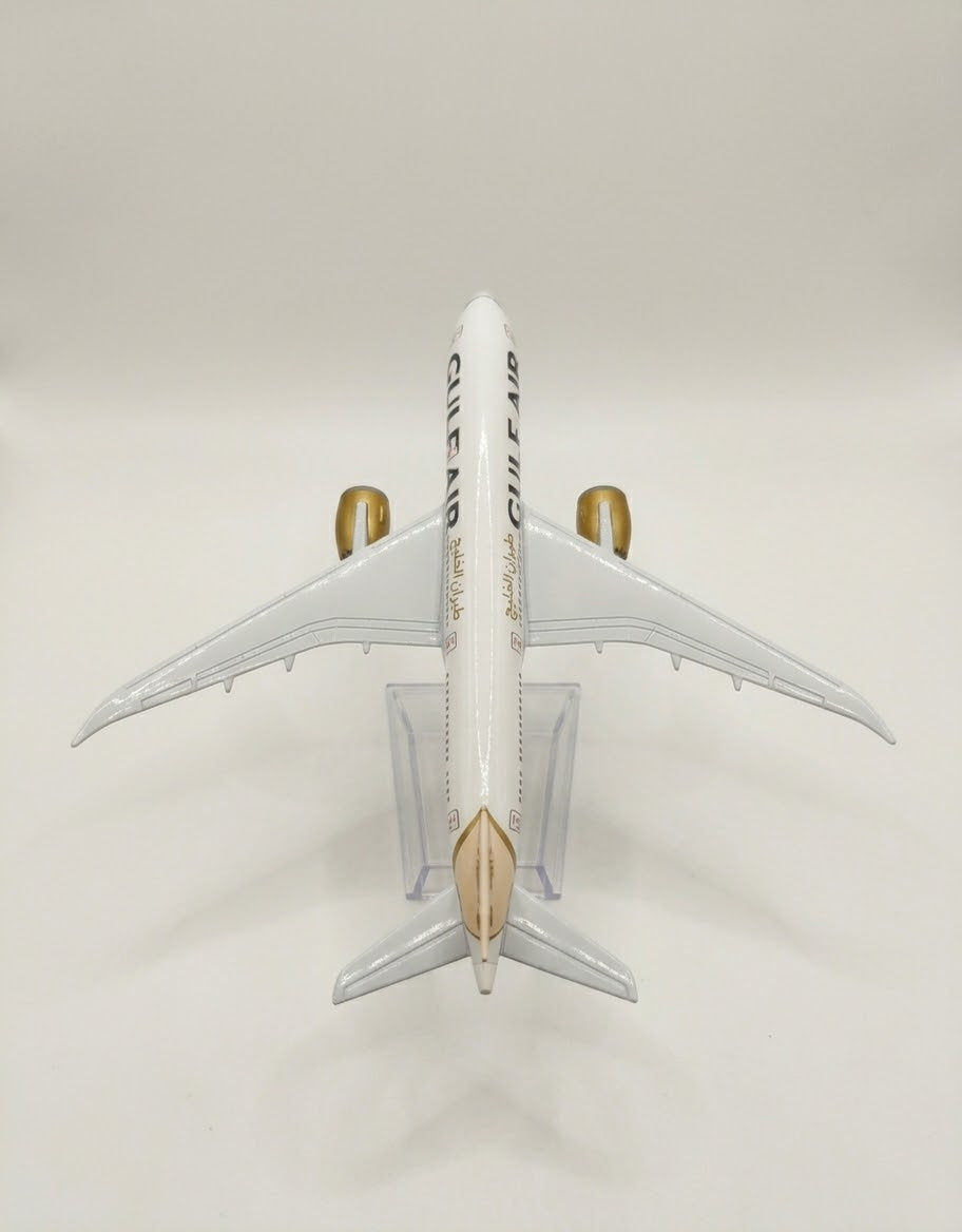 Overhead top view of Gulf Air diecast aircraft model showing fuselage markings, gold engine nacelles, and detailed wingspan.