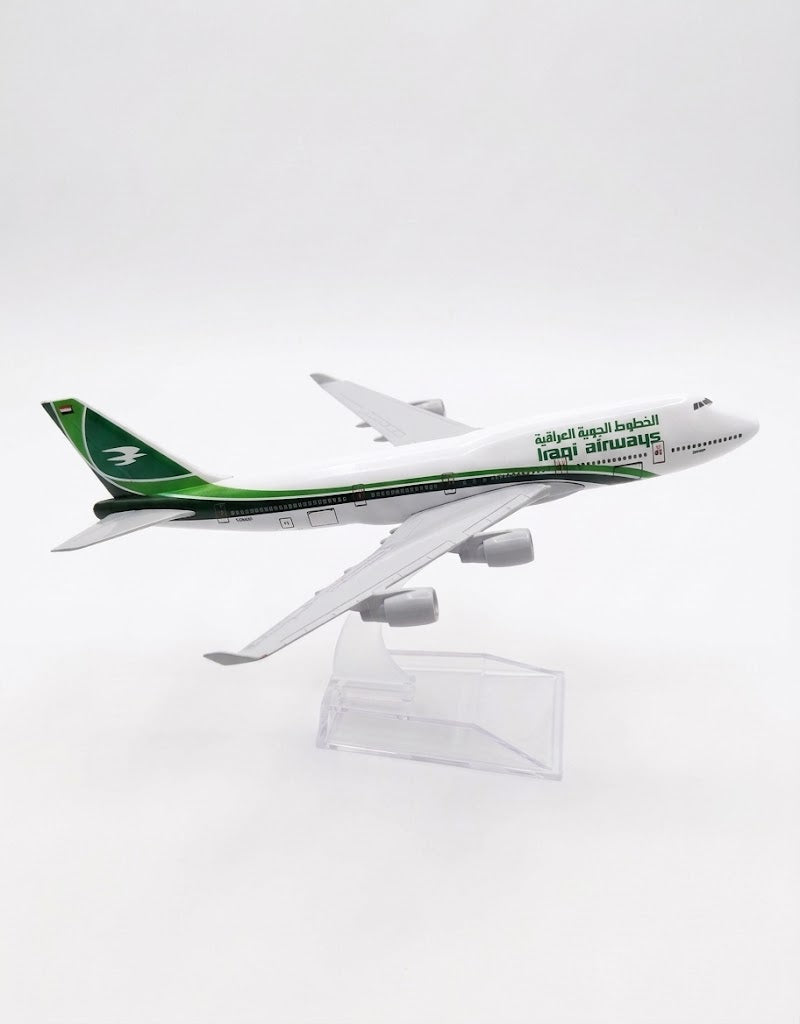 Side profile of Iraqi Airways Boeing 747 metal model showing official green livery and Arabic calligraphy.