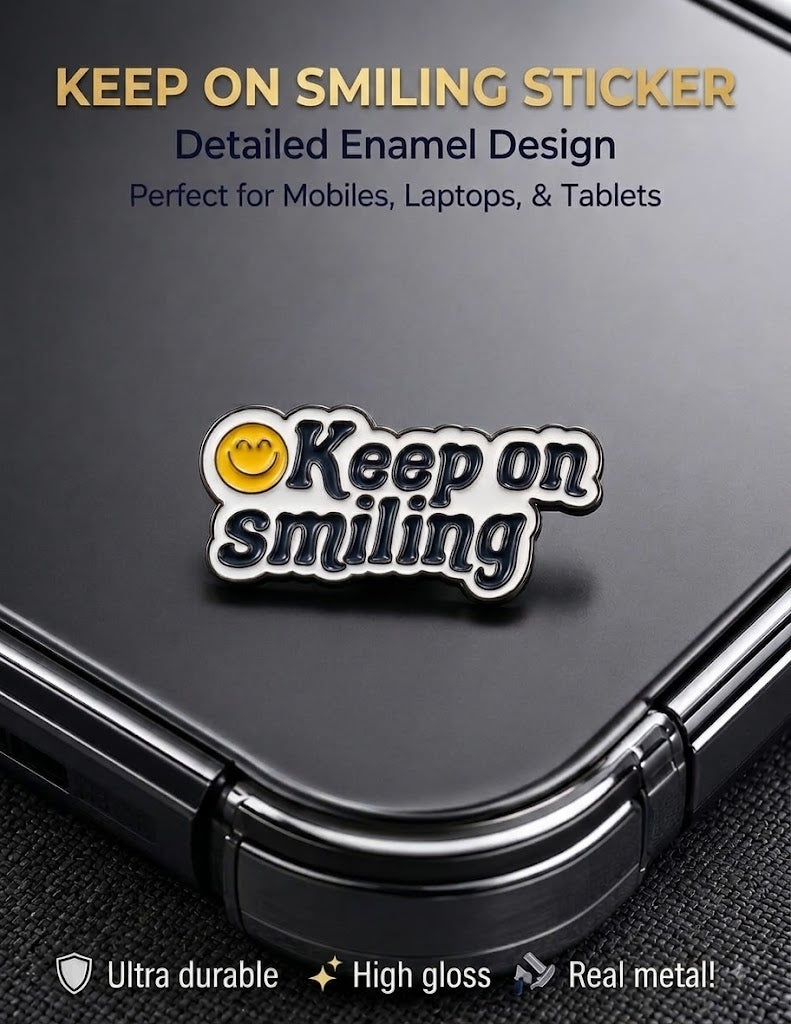 Glossy Keep On Smiling enamel metal sticker with yellow smiley face on a black smartphone.