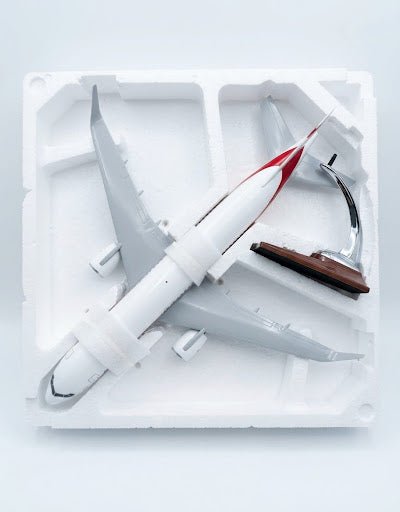 Top-down unboxing view of MEA Middle East Airlines aircraft model and display stand securely nested in foam tray