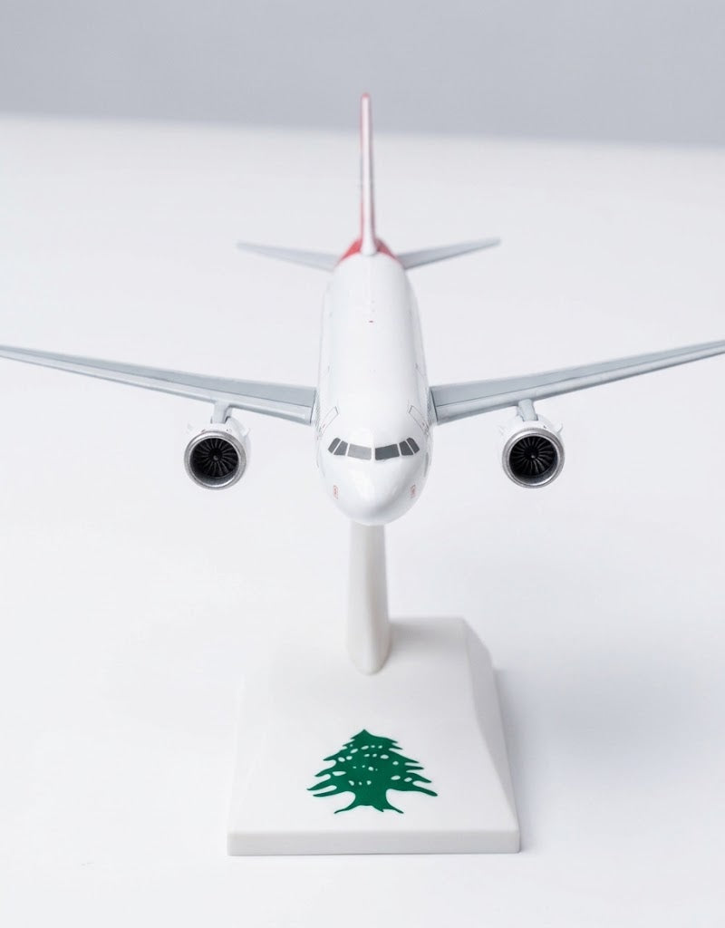 Head-on view of MEA Airbus A320 collectible display plane showing cockpit windows, twin engines, and cedar base stand.