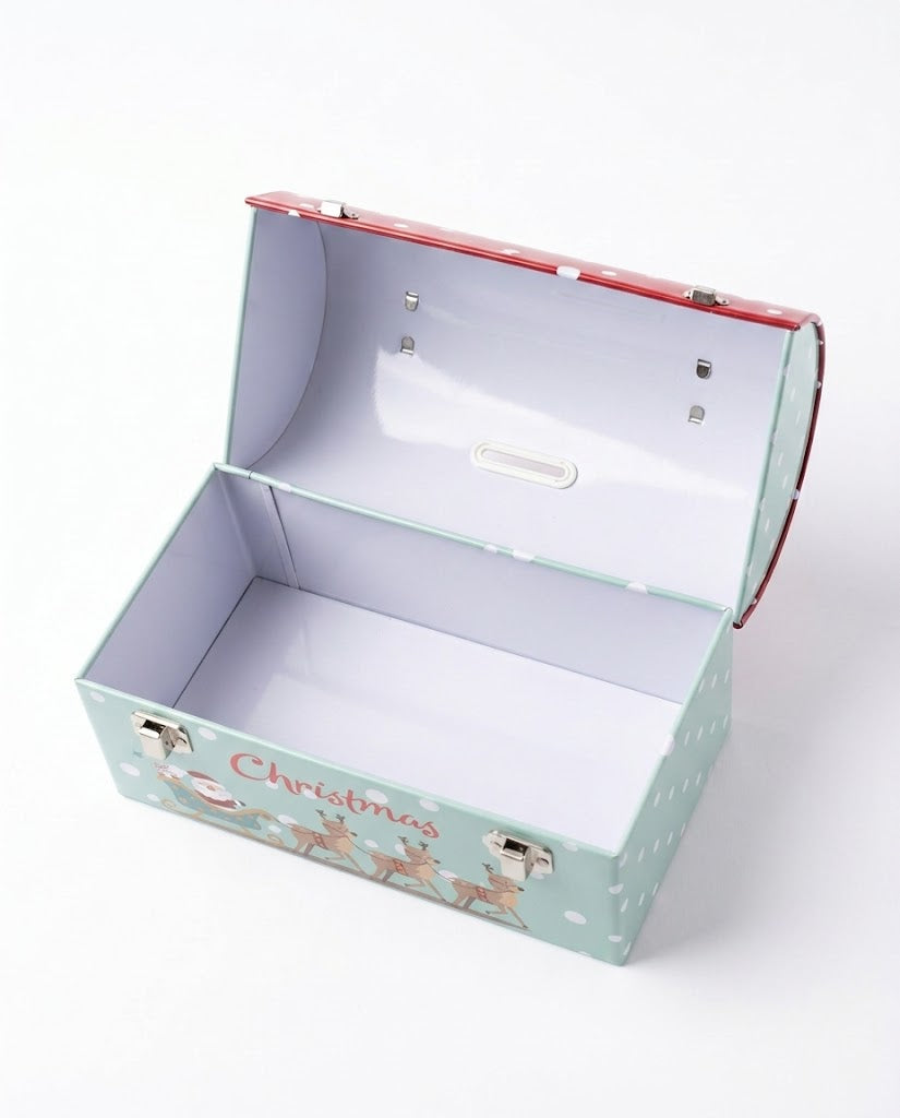 Open interior view of Christmas metal tin keepsake box showing empty storage space and top lid coin slot on a white background.