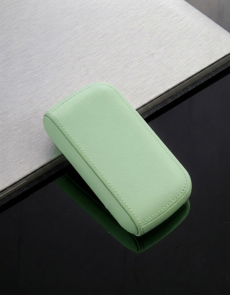 Pastel mint green leather-style cigarette case with built-in rechargeable lighter for safe, crush-proof pocket storage.