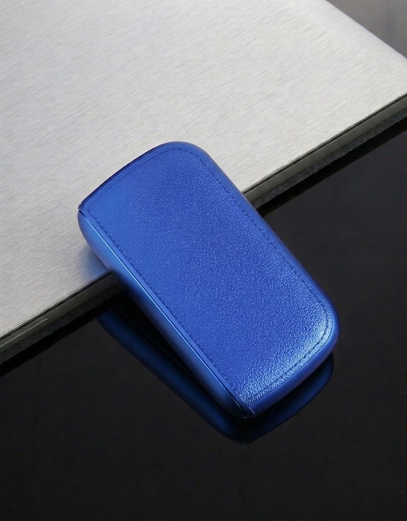 Slim royal blue moisture-proof pocket cigarette case with integrated electronic lighter and automatic lock closure.