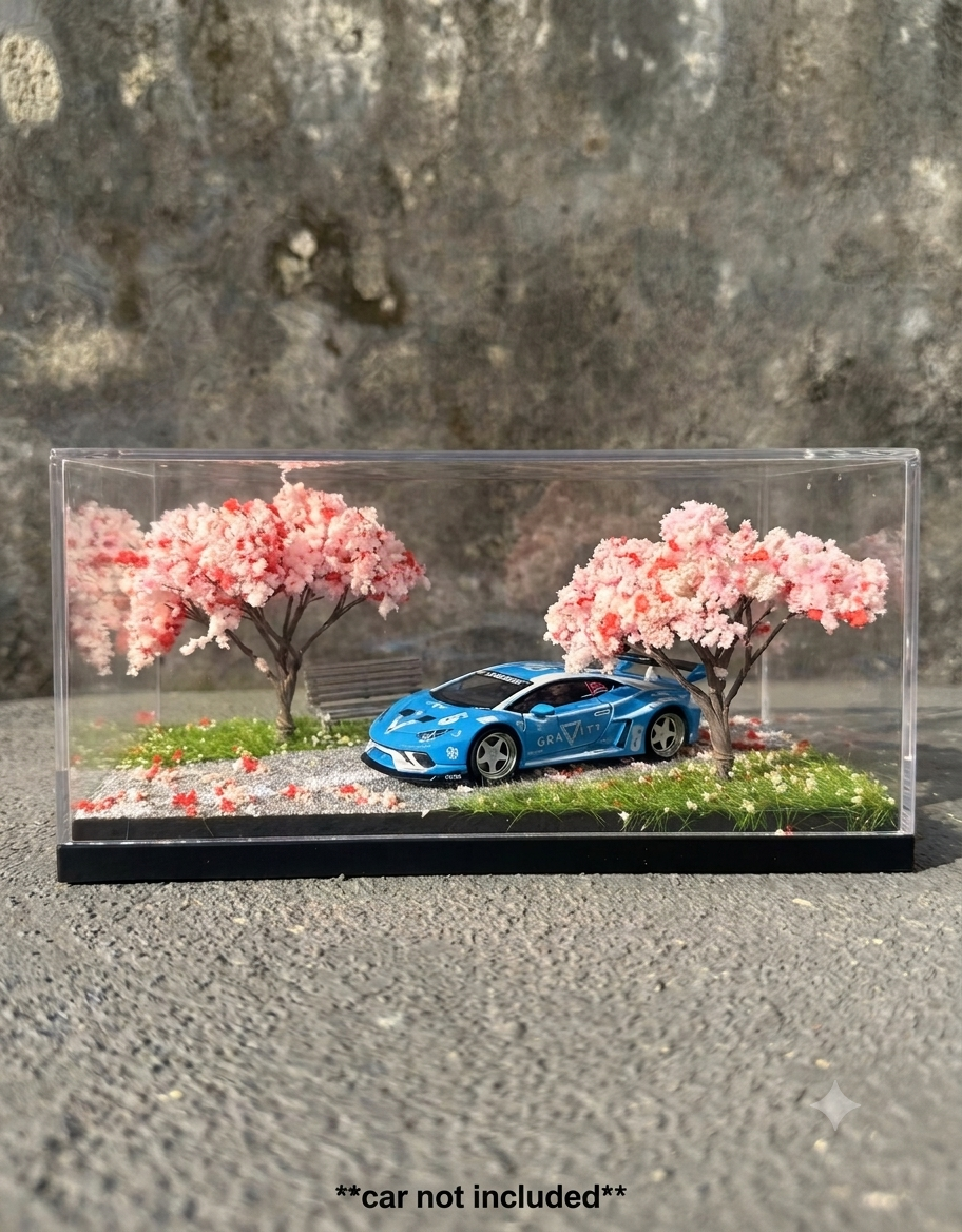 Realistic 1:64 scale miniature sakura park diorama featuring pink blossom trees, gravel path, and diecast supercar.