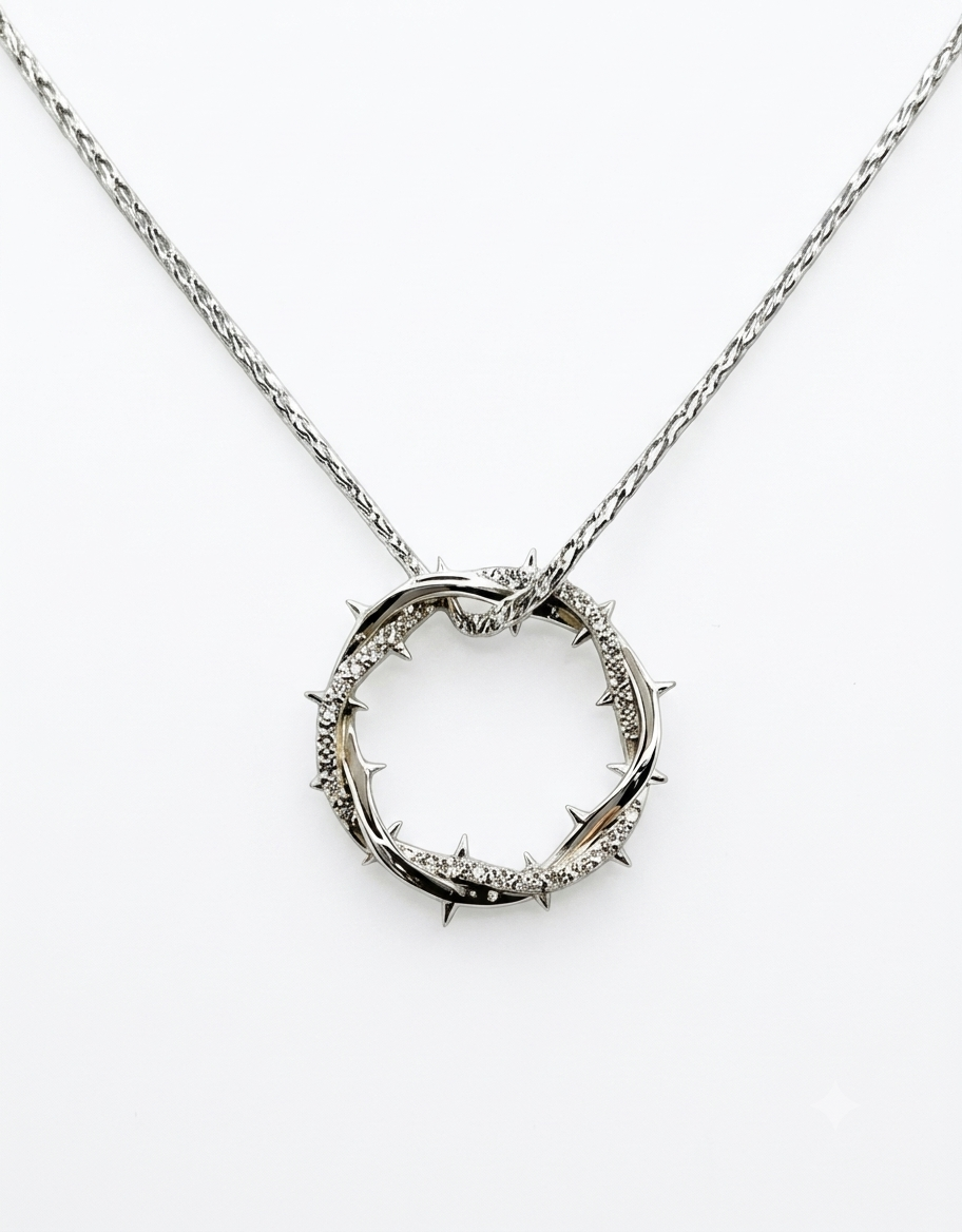 Silver stainless steel crown of thorns pendant necklace accented with sparkling micro-pavé CZ stones on an interwoven rope chain.