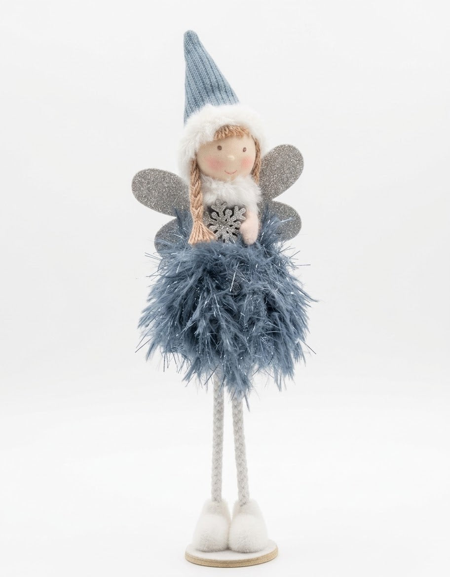 Standing plush winter fairy figurine featuring an ice blue feathered skirt, glitter wings, and knit beanie holding a silver snowflake.