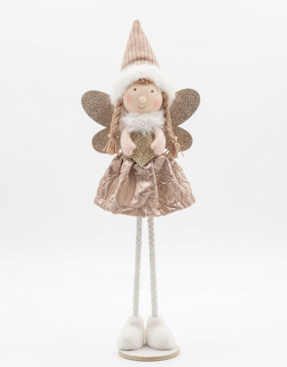 Standing plush holiday fairy figurine dressed in a rose gold metallic dress, pointed knit hat, and glitter wings holding a gold heart.