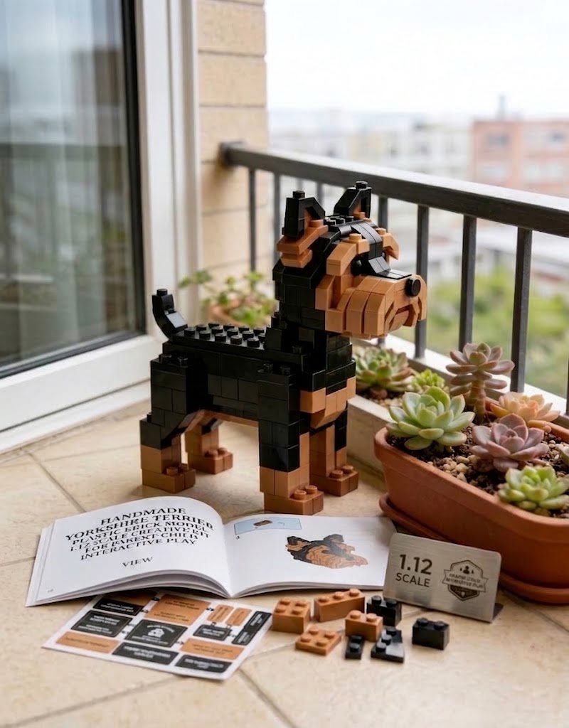 1:12 scale Yorkshire Terrier building brick model shown with assembly guide booklet, spare bricks, and potted succulents.